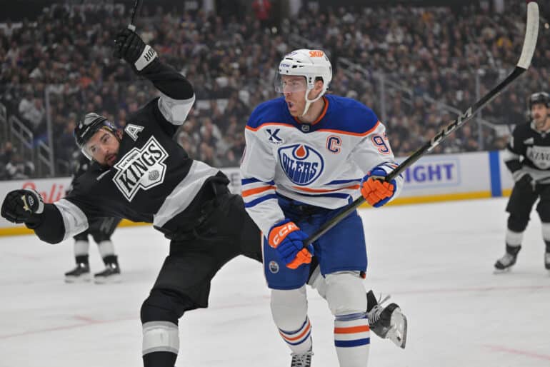 Apr 23, 2025; Los Angeles, California, USA;  Los Angeles Kings defenseman Drew Doughty (8) and Edmonton Oilers center Connor McDavid (97) battle on the ice in the first period of game 2 of the 2025 Stanley Cup Playoffs at Crypto.com Arena. Mandatory Credit: Jayne Kamin-Oncea-Imagn Images