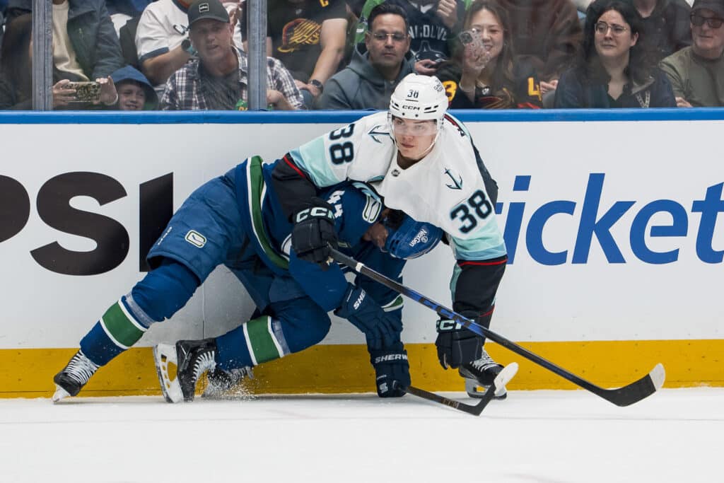 Sep 26, 2025; Vancouver, British Columbia, CAN; Seattle Kraken forward Jani Nyman (38) battles with Vancouver Canucks forward Kiefer Sherwood (44) in the second period at Rogers Arena. Mandatory Credit: Bob Frid-Imagn Images