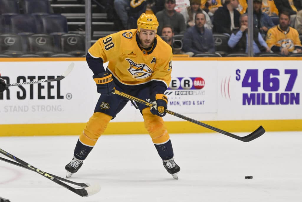 Nov 6, 2025; Nashville, Tennessee, USA; Nashville Predators center Ryan O'Reilly (90) skates with the puck against the Philadelphia Flyersduring the first period at Bridgestone Arena. Mandatory Credit: Steve Roberts-Imagn Images