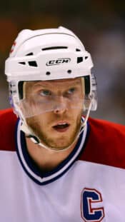 Jan 27, 2007; Toronto, ON, Canada; Montreal Canadiens center (11) Saku Koivu looks on against the Toronto Maple Leafs center (21) John Pohl at the Air Canada Centre in Toronto, ON. Mandatory Credit: Tom Szczerbowski-USA TODAY Sports